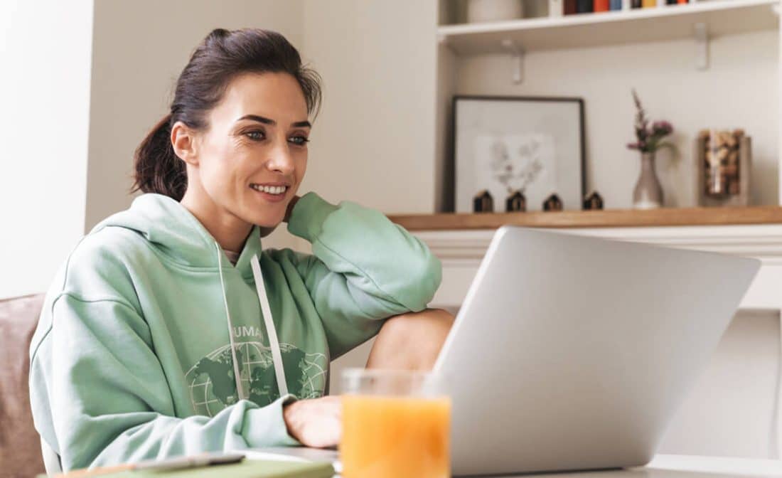 woman sitting in living room at laptop