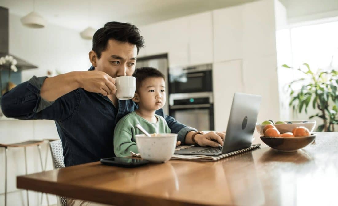 dad and son sitting in front of laptop