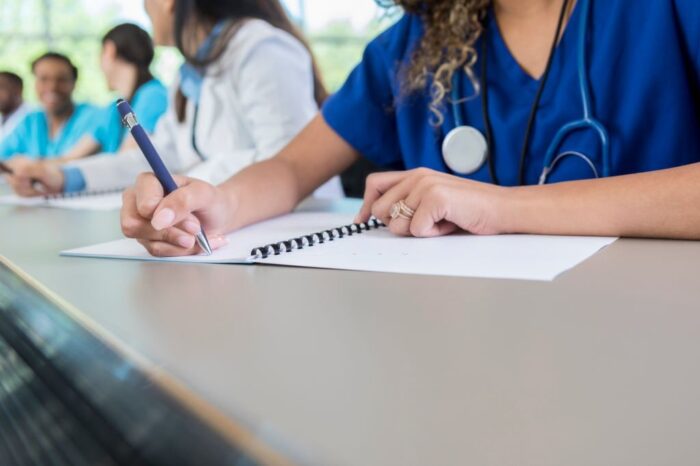 female nursing student writing on paper