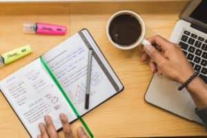 Open Notebook and Coffee Cup